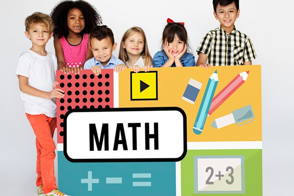 Happy children learning math with colorful school supplies.