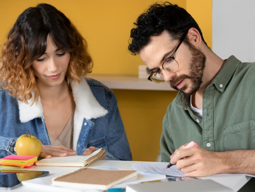 Couple reviewing documents together at a table in a cozy setting.